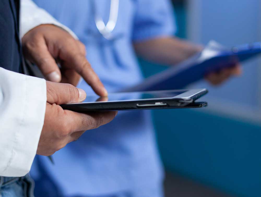 close-up-medic-pointing-tablet-screen-medical-practice-working-late-doctor-using-modern-device-with-touch-screen-talking-assistant-about-healthcare-system-overtime-